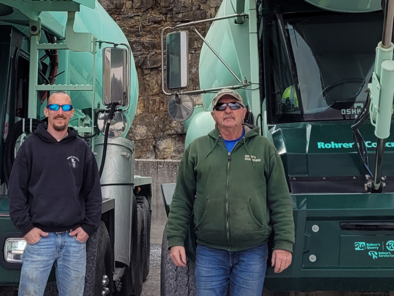 Concrete mixer drivers standing by their clean trucks