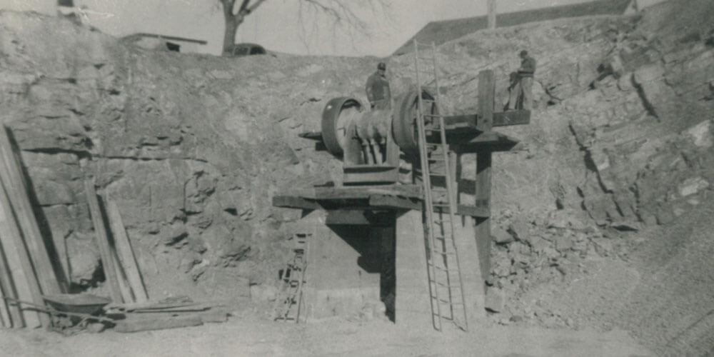 black and white photo of the first crushing plant at Rohrer's being operated by two men in 1949