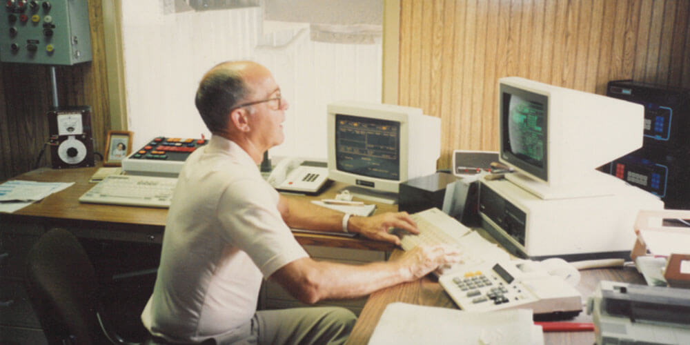 An man working at an old computer in 1990