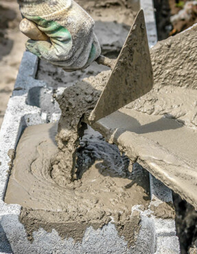 concrete being poured into cinderblocks