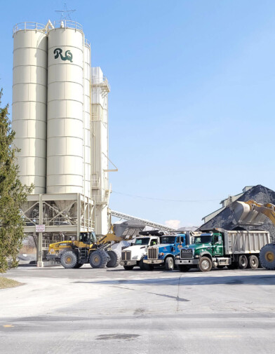 A view of Rohrer's Quarry product silos, trucks, and rock piles