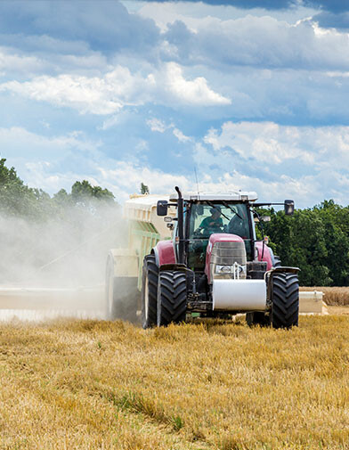 a spinner spreader spraying damp lime on a field